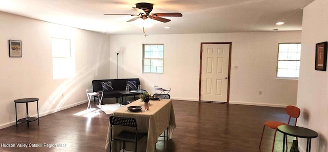 living room with dark hardwood / wood-style floors and ceiling fan