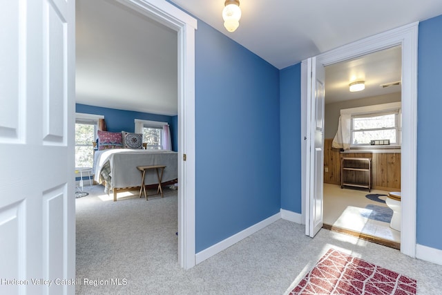 hallway featuring light colored carpet