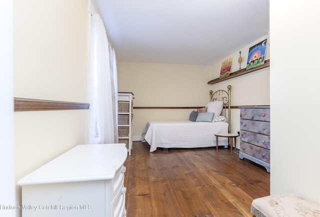 bedroom with dark hardwood / wood-style floors