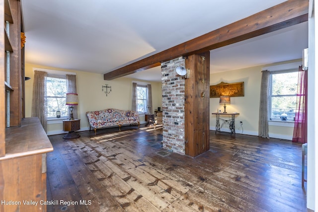 unfurnished living room with beamed ceiling and dark hardwood / wood-style flooring