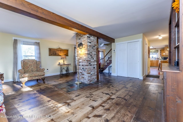 living room featuring beam ceiling, ornate columns, and dark hardwood / wood-style flooring