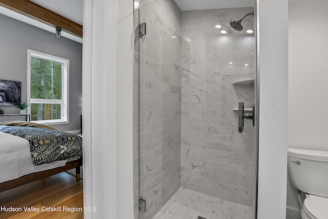 bathroom featuring hardwood / wood-style flooring, toilet, beamed ceiling, and an enclosed shower