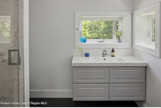 bathroom featuring an enclosed shower and vanity