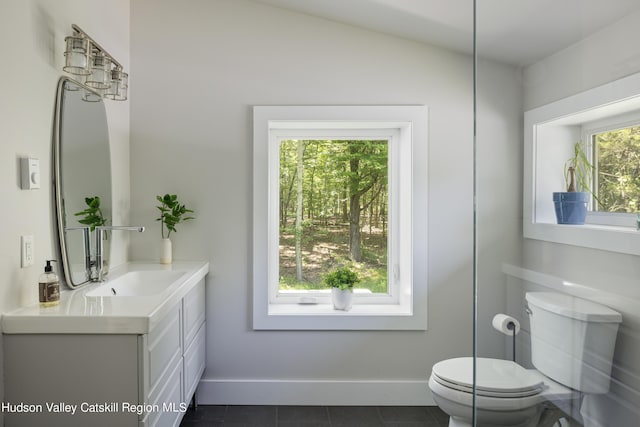 bathroom with vanity, toilet, and tile patterned floors