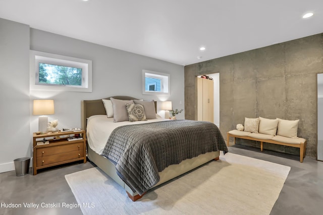 bedroom featuring concrete floors