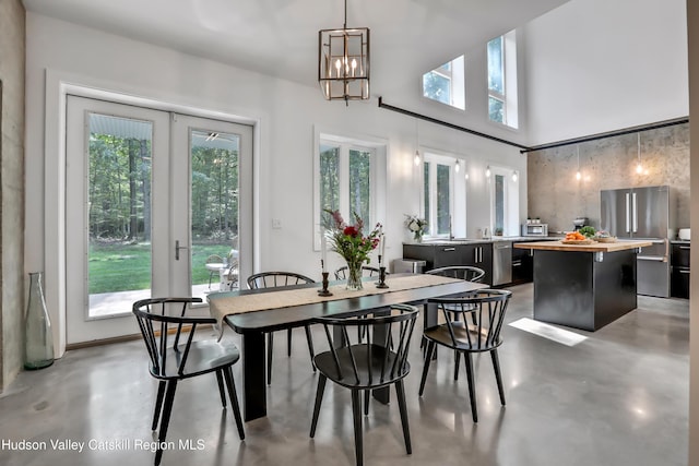 dining area with a notable chandelier and french doors