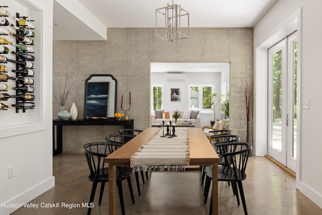 dining room featuring concrete floors and a wall mounted AC