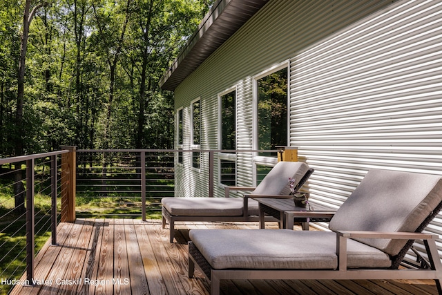 deck featuring a covered hot tub