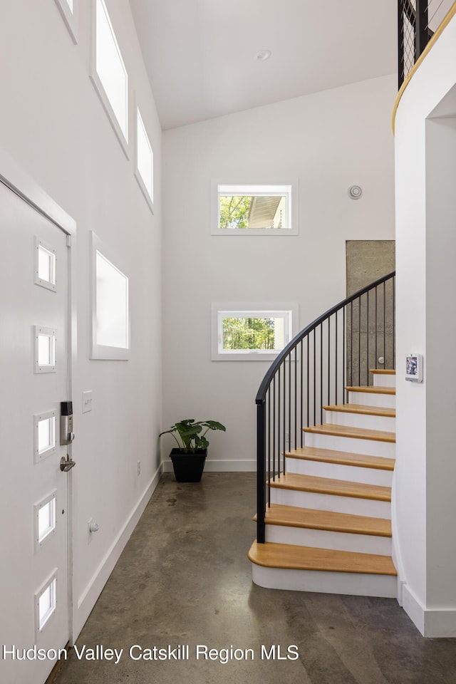 entrance foyer featuring a towering ceiling