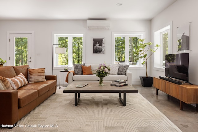 living room with a wall unit AC and a healthy amount of sunlight