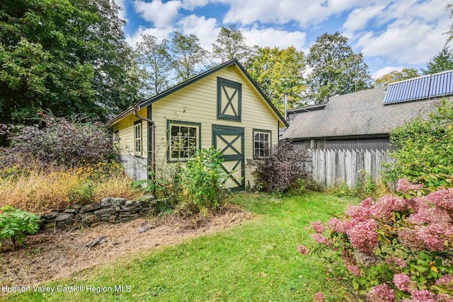 view of outbuilding with a lawn