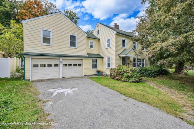 view of front property with a garage and a front lawn