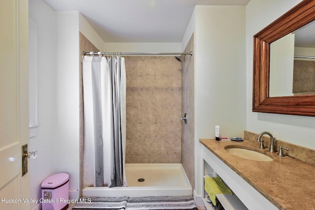 bathroom with curtained shower and vanity