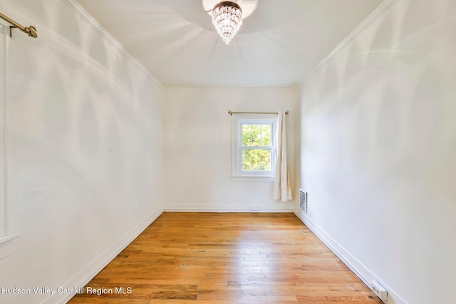 unfurnished room with crown molding and light wood-type flooring