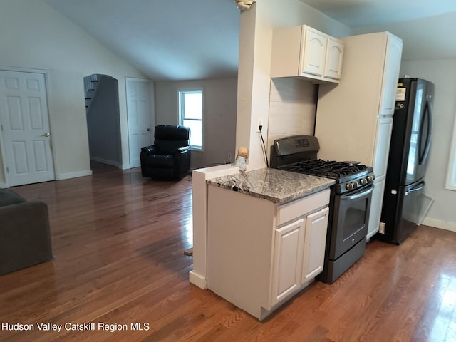 kitchen with lofted ceiling, dark wood-type flooring, black appliances, white cabinets, and light stone countertops