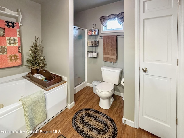 199 Echo Hill Rd, Saugerties, NY 12477 - bathroom with toilet, baseboards, wood finished floors, a bath, and a stall shower