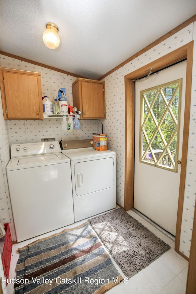 199 Echo Hill Rd, Saugerties, NY 12477 - laundry room with ornamental molding, wallpapered walls, cabinet space, and washer and clothes dryer