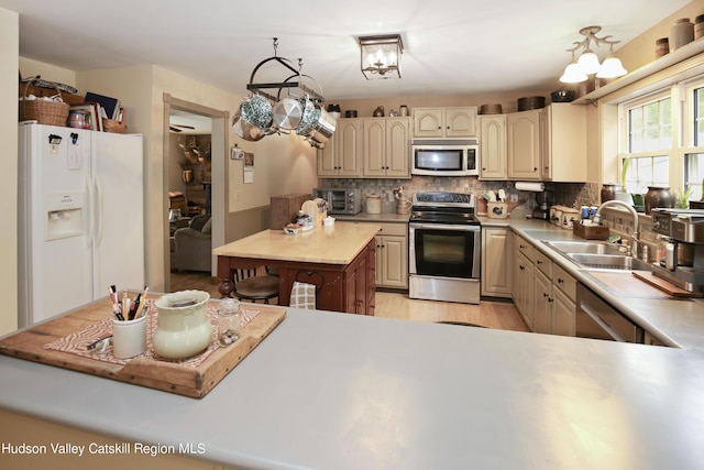 199 Echo Hill Rd, Saugerties, NY 12477 - kitchen featuring decorative backsplash, a sink, light countertops, light wood finished floors, and stainless steel appliances