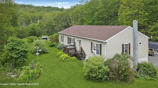 199 Echo Hill Rd, Saugerties, NY 12477 - view of front of house featuring a wooden deck, a front yard, roof with shingles, a chimney, and a wooded view