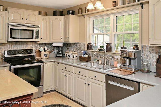 199 Echo Hill Rd, Saugerties, NY 12477 - kitchen with a sink, light wood-style floors, light countertops, stainless steel appliances, and backsplash