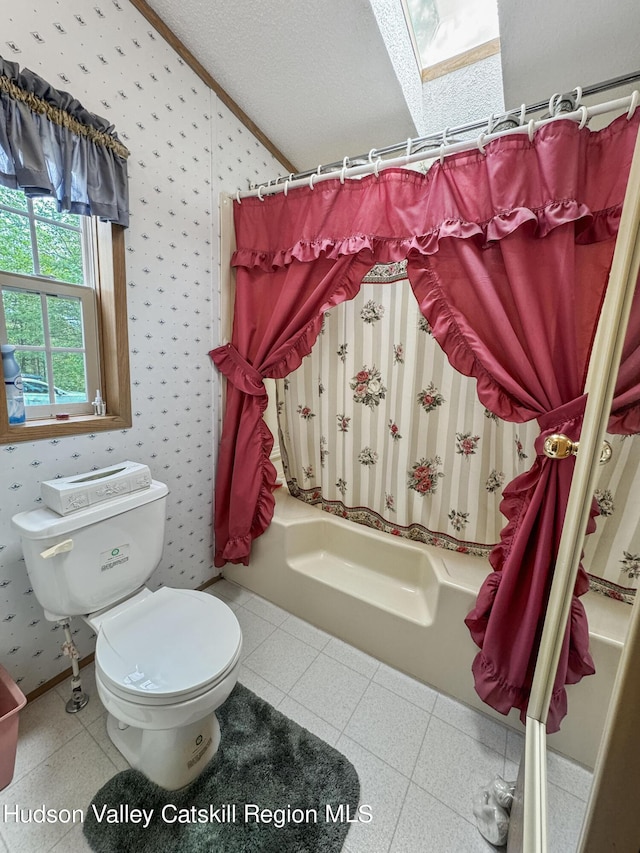 199 Echo Hill Rd, Saugerties, NY 12477 - full bathroom featuring wallpapered walls, toilet, and lofted ceiling with skylight