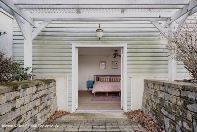 view of exterior entry featuring a pergola