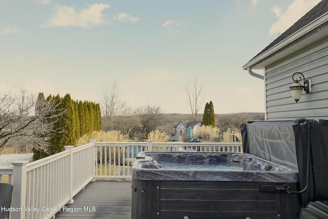 wooden deck featuring a hot tub