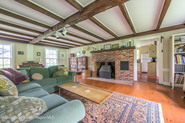 1250 County Route 351, Rensselaerville, NY 12147 - living room featuring beamed ceiling, wood-type flooring, and a wood stove