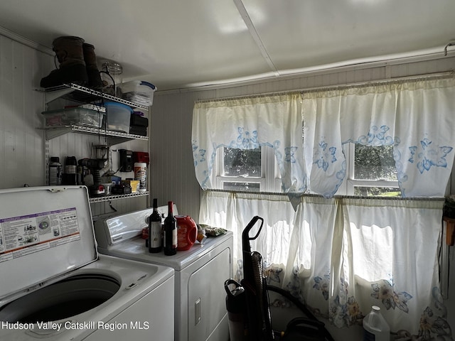 clothes washing area with washing machine and dryer