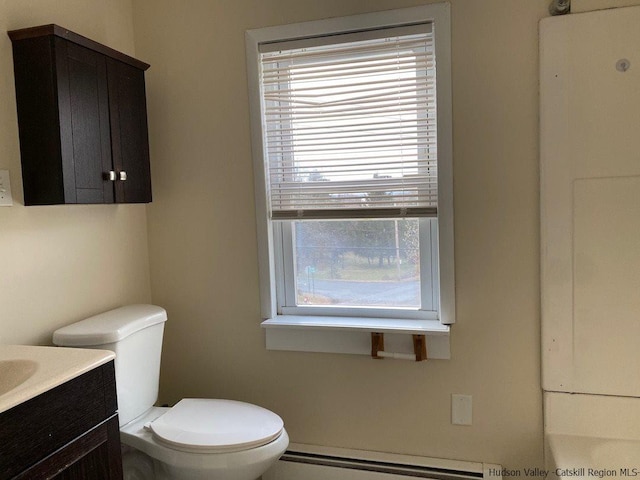 bathroom featuring vanity, a baseboard radiator, and toilet