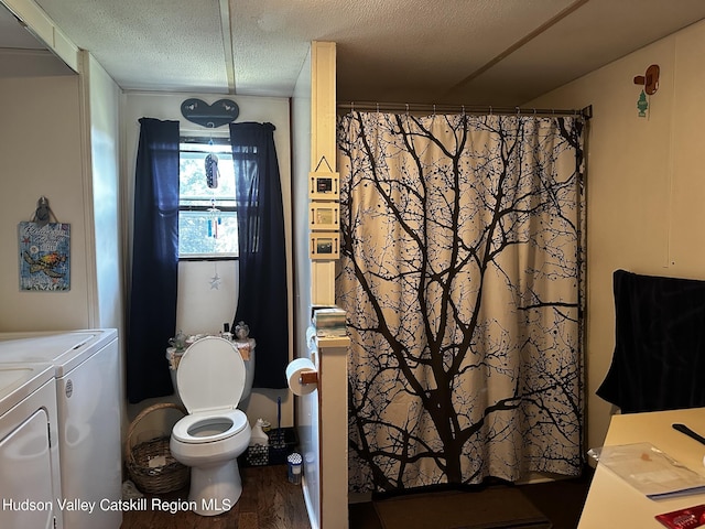 bathroom with hardwood / wood-style floors, a shower with shower curtain, toilet, a textured ceiling, and washing machine and clothes dryer