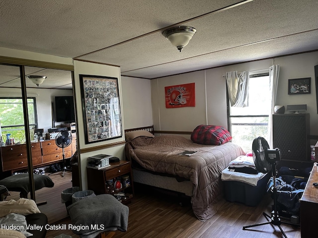 bedroom with wood-type flooring and a textured ceiling