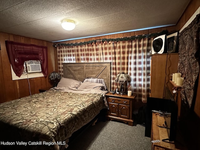 carpeted bedroom featuring a textured ceiling, cooling unit, and wood walls