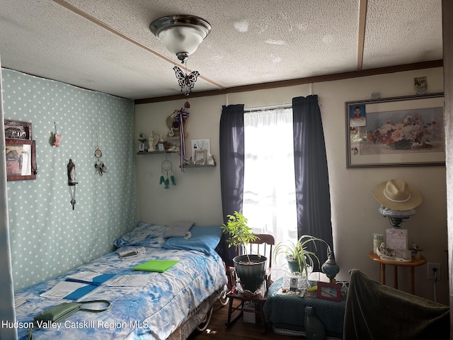 bedroom featuring hardwood / wood-style floors and a textured ceiling