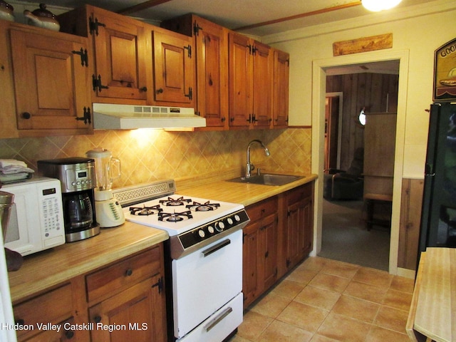 70 Watson Hollow Rd, West Shokan, NY 12494 - kitchen with white appliances, under cabinet range hood, light countertops, backsplash, and brown cabinets