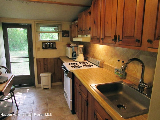 70 Watson Hollow Rd, West Shokan, NY 12494 - kitchen with white appliances, under cabinet range hood, decorative backsplash, brown cabinetry, and light tile patterned floors