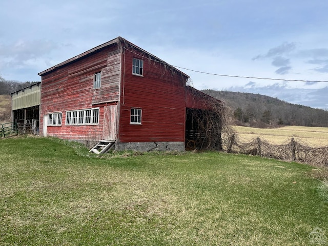 view of side of home with a yard