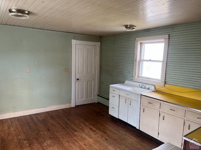 kitchen with dark wood-type flooring, baseboard heating, white cabinets, wood ceiling, and light countertops