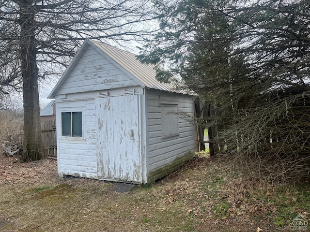 view of shed featuring fence