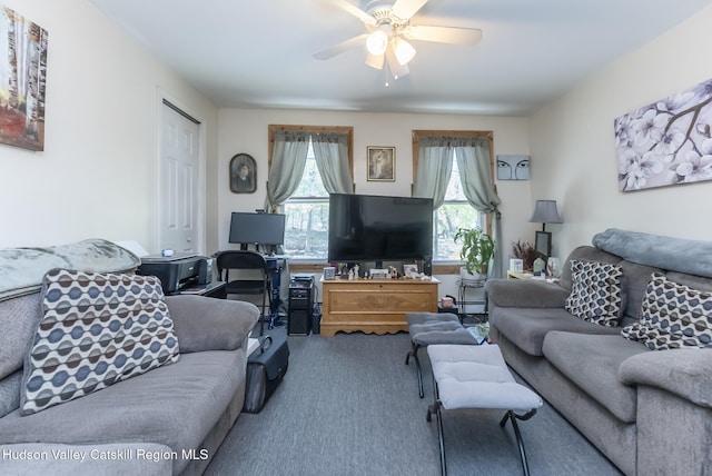 living area featuring carpet floors and ceiling fan