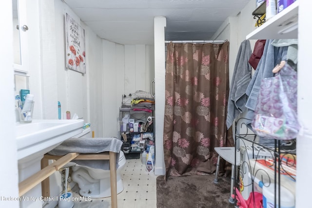 bathroom with tile patterned floors and curtained shower