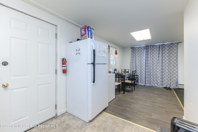 kitchen featuring freestanding refrigerator and a baseboard radiator
