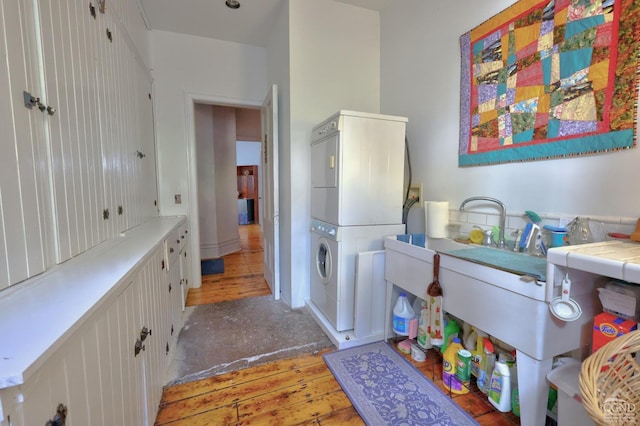 380 Main St, New Baltimore, NY 12124 - bathroom with stacked washer and clothes dryer and wood-type flooring