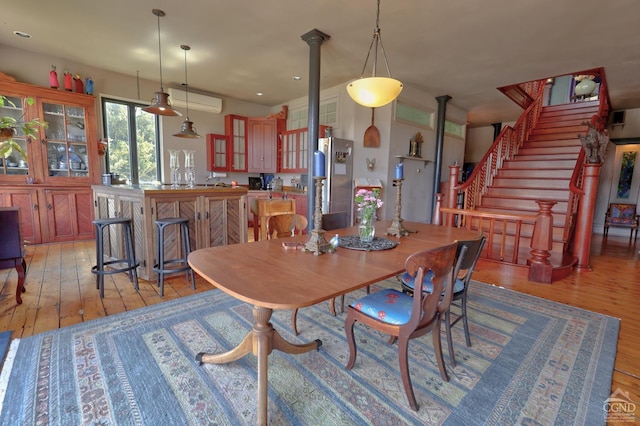 380 Main St, New Baltimore, NY 12124 - dining space featuring light wood-style floors, stairway, and ornate columns
