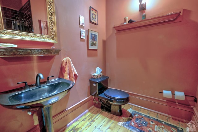 380 Main St, New Baltimore, NY 12124 - bathroom featuring wood finished floors, toilet, baseboards, and a sink