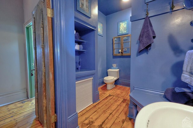 380 Main St, New Baltimore, NY 12124 - bathroom featuring hardwood / wood-style flooring, toilet, and a sink