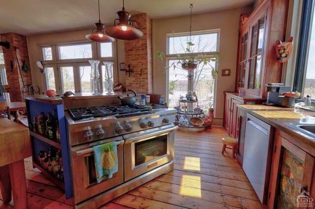 380 Main St, New Baltimore, NY 12124 - kitchen with appliances with stainless steel finishes, light wood finished floors, hanging light fixtures, and light countertops