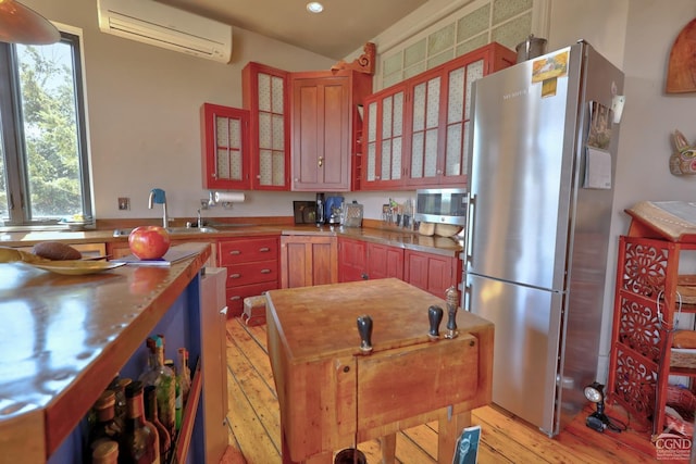 380 Main St, New Baltimore, NY 12124 - kitchen featuring a wall mounted air conditioner, stainless steel appliances, light wood-style flooring, healthy amount of natural light, and recessed lighting