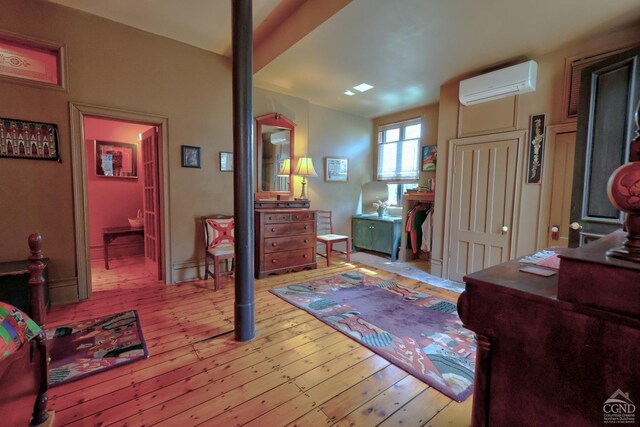 380 Main St, New Baltimore, NY 12124 - bedroom featuring a wall mounted AC and hardwood / wood-style floors