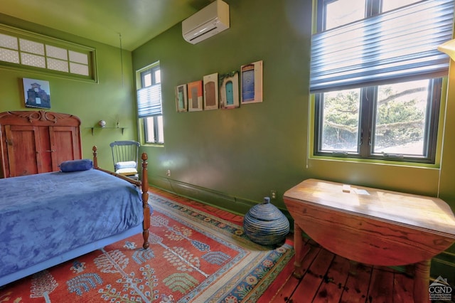 380 Main St, New Baltimore, NY 12124 - bedroom featuring a wall mounted air conditioner, wood finished floors, and baseboards